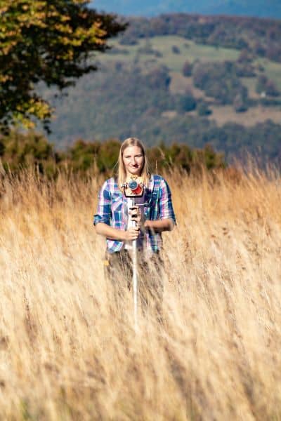 Land surveyor collecting field measurements with tripod equipment, showing the precision and groundwork behind every ALTA survey