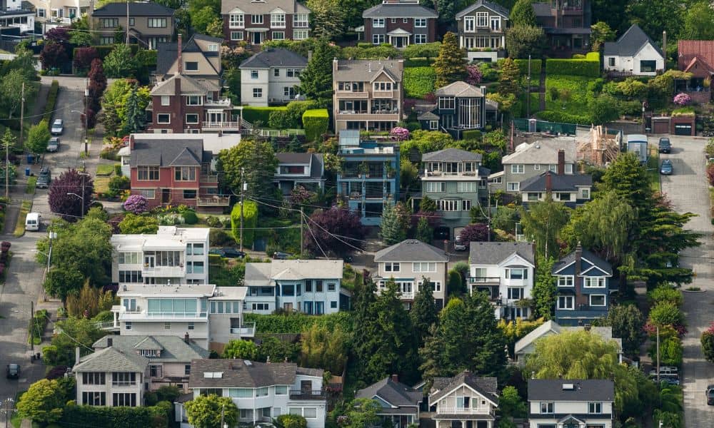 Aerial view of hillside homes where elevation surveys help show how changing flood zones and land movement affect each property