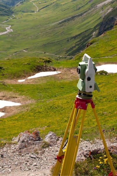 Surveying equipment set up on a hillside to measure ground levels and support accurate elevation surveys on sloped terrain